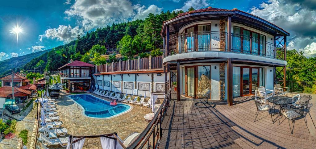 a large house with a swimming pool on a deck at При Баръма in Vishnevo