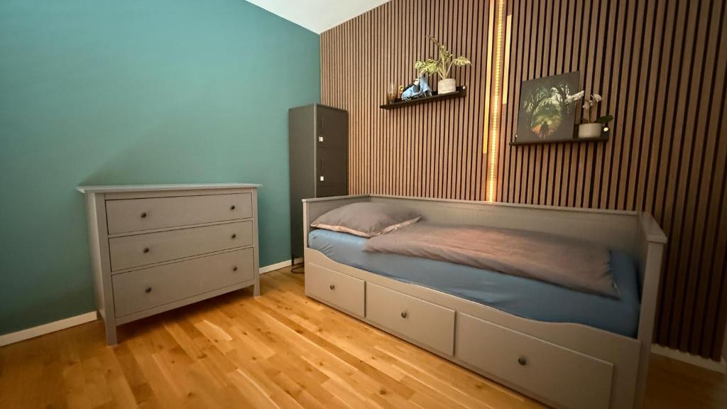 una camera da letto con un letto e una cassettiera di Moderne Penthousewohnung in Zentrumsnähe a Lipsia