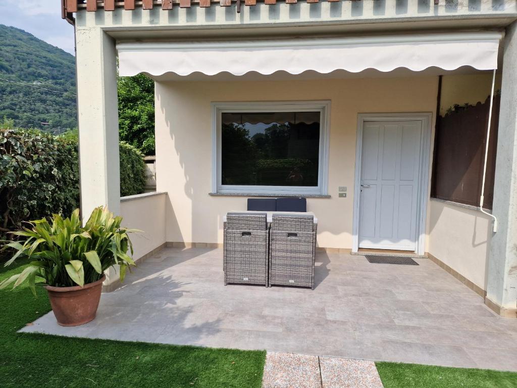 a screened in porch with a television on a house at La Casetta al Lago in Sorico