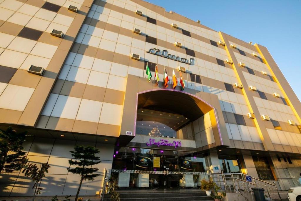 a building with a sign on the front of it at Lamasat Al Ajnaha Serviced Apartments in Abha