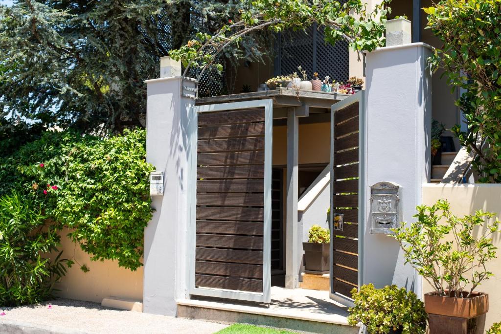 an entrance to a house with a wooden door at Sofi's Cozy House Near Athens Airport in Artemida