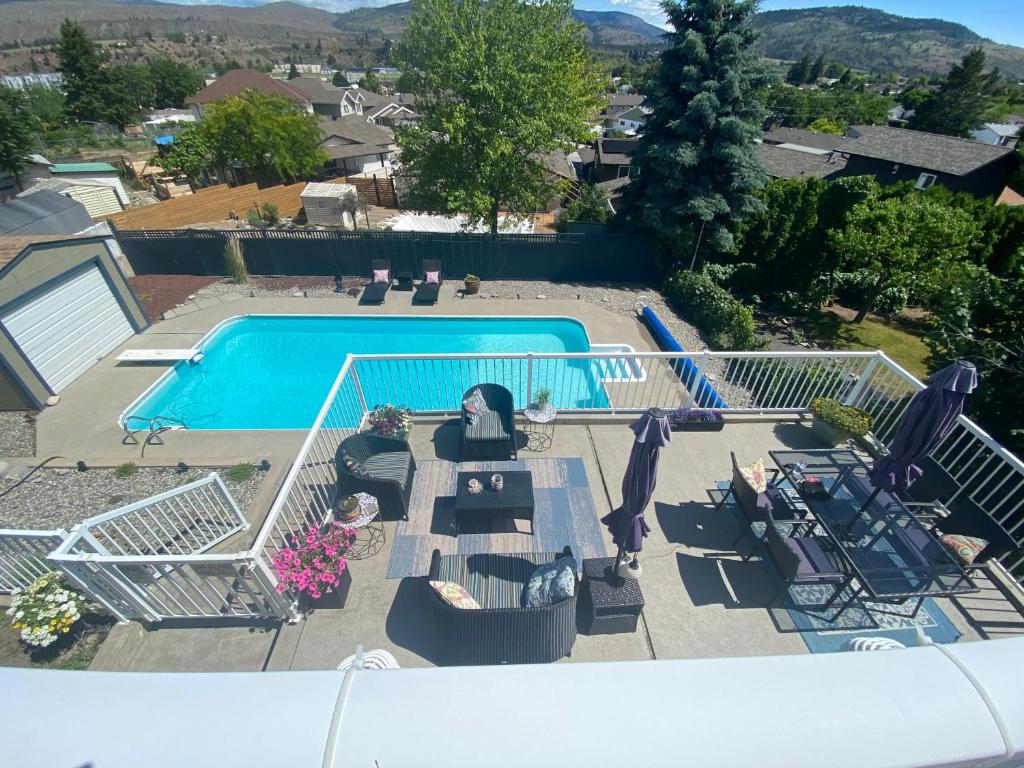 an overhead view of a swimming pool with chairs and a patio at Mountain View Villa with Saltwater Pool in Oliver