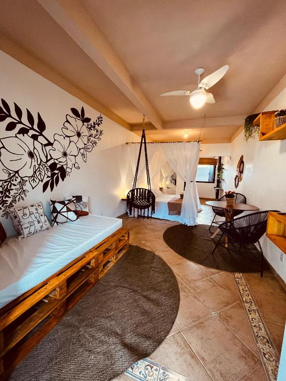 a living room with a bed and a swing at Villa Tiê Paraty in Paraty