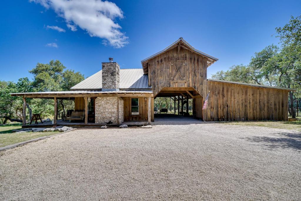 a large wooden barn with a garage at Swim, Hike and Unwind Serene Hill Country Retreat in Kerrville
