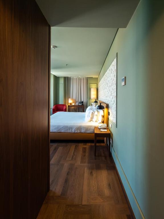 A narrow view into a furnished guest room from the entryway.