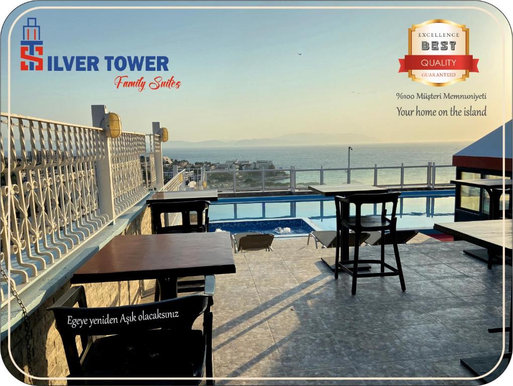 a balcony with tables and a view of the ocean at Silver Tower Family Apart Otel in Kuşadası