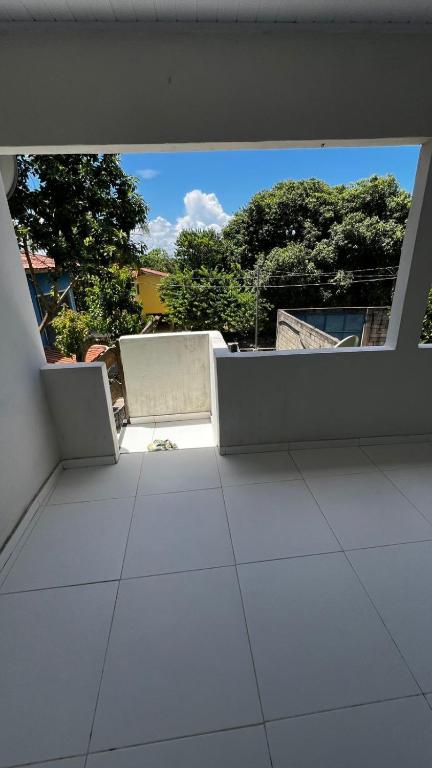 an empty room with a view of a building at Casa da Val in Conceição da Barra