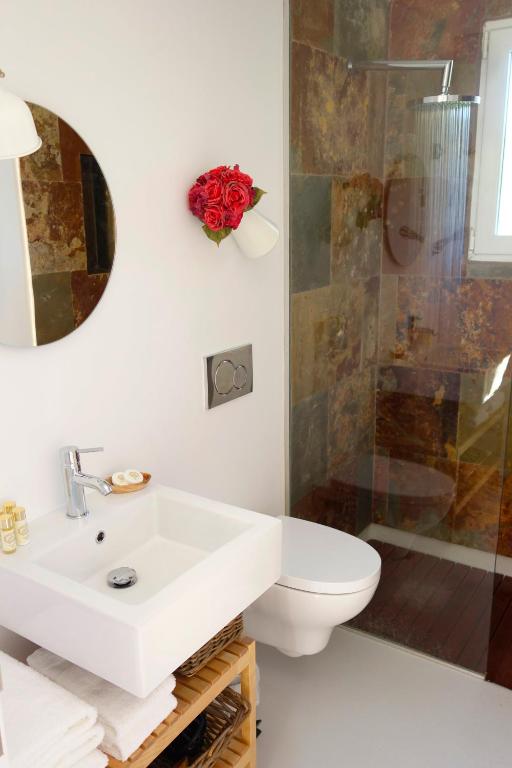 a bathroom with a sink and a toilet and a shower at Sparrow Sintra Nest in Sintra