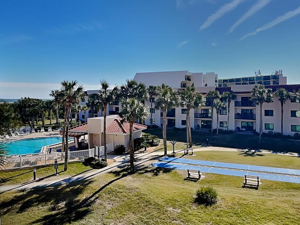 an aerial view of a resort with a pool and palm trees at Ocean Village Club Q32 in Butler Beach