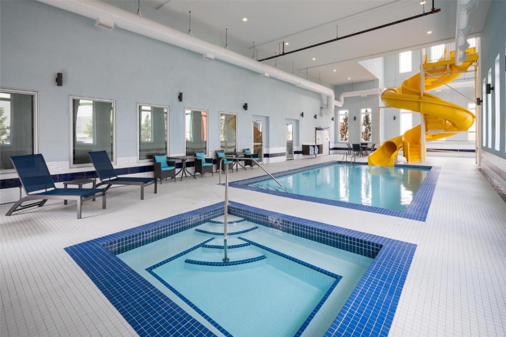 a swimming pool with a slide in a building at Best Western Premier Executive Residency Medicine Hat in Medicine Hat