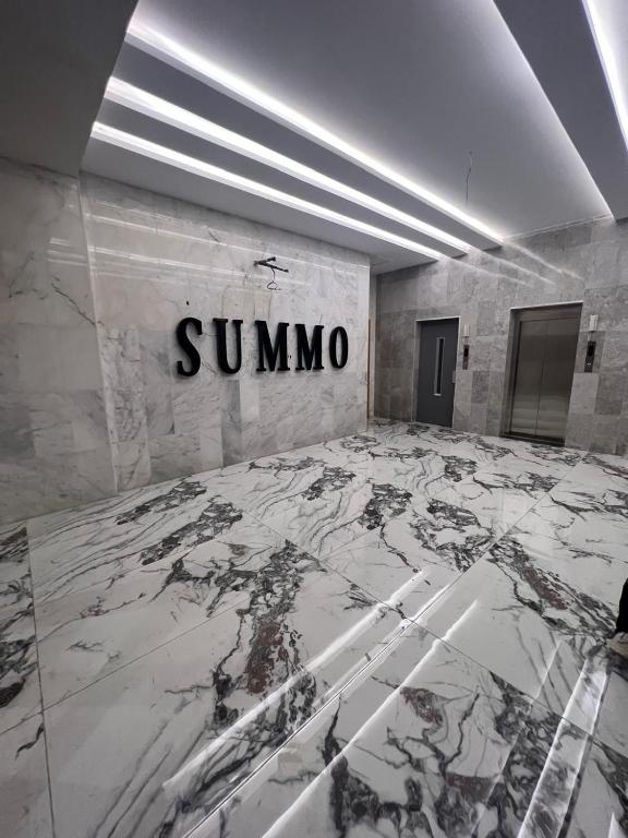a room with a sign on a wall with a marble floor at Summo bilding in Jeddah