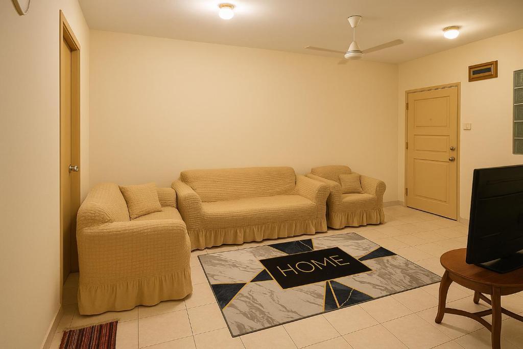 a living room with two chairs and a sign that says love at Country heights Homestay in Donggongon