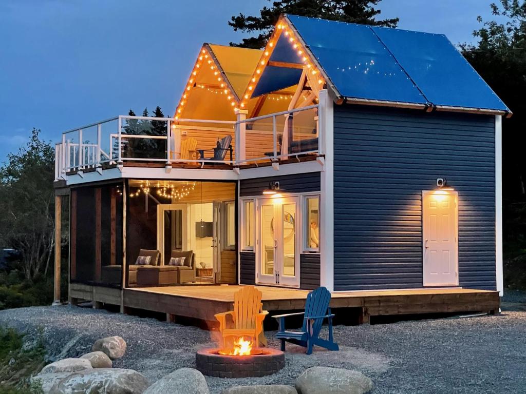 a small house with two chairs in front of it at Whitecaps Cabana for Couples in La Have