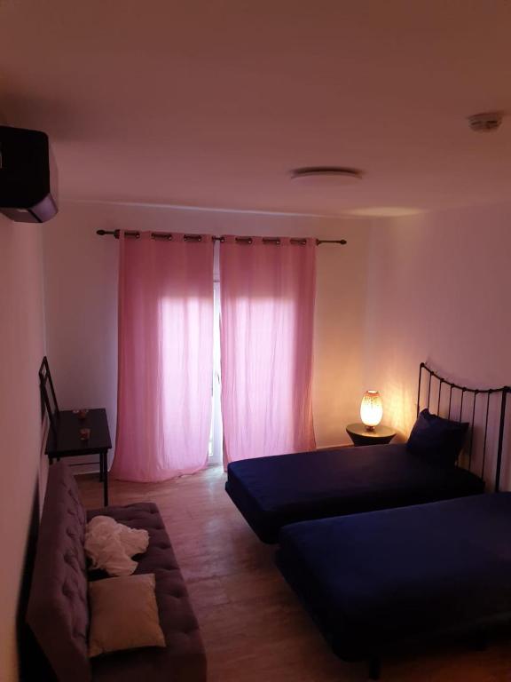 a living room with two beds and a couch at Madame facances in Saïdia