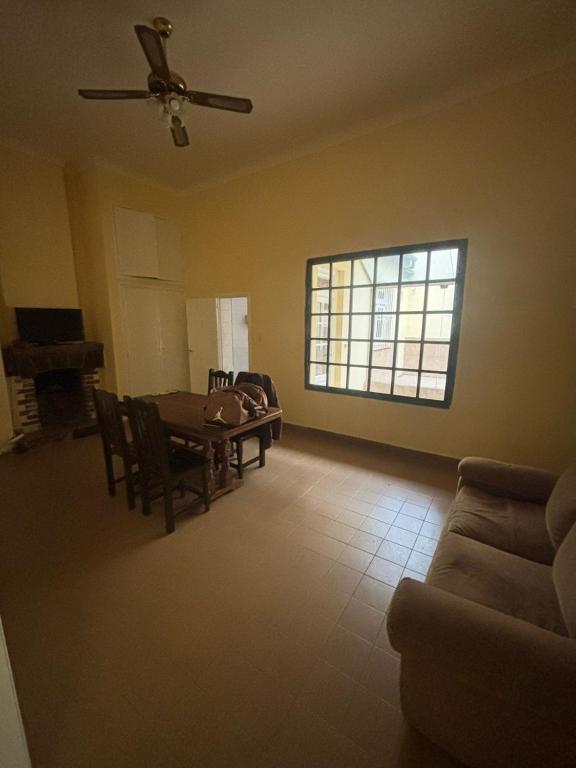 a living room with a table and chairs and a window at Casa en el Corazon de Salta Capital a 1 cuadra de la Plaza 9 de Julio in Salta