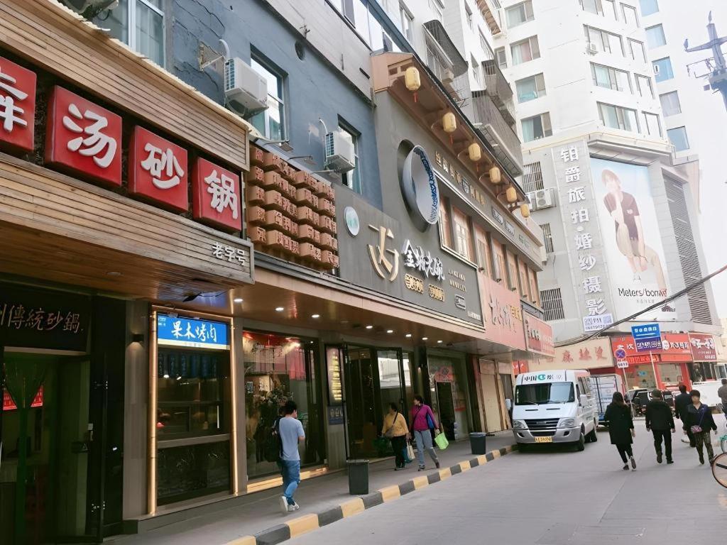 a busy city street with people walking in front of buildings at Jun Hotel Gansu Lanzhou Chengguan District Zhangye Road Walking Street in Lanzhou