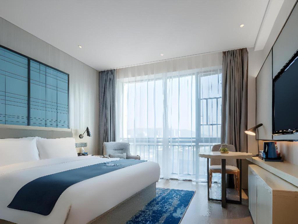 Ένα ή περισσότερα κρεβάτια σε δωμάτιο στο Echarm Hotel Changsha Yuelu Mountain West Bus Station Metro Station