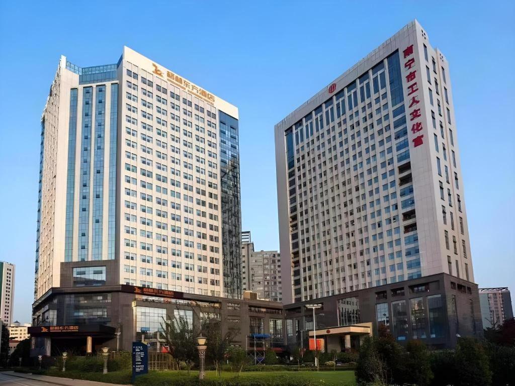two tall skyscrapers in a city at GreenTree Eastern Hotel Nanning Minzhu Road Chaoyang Plaza in Shanglin