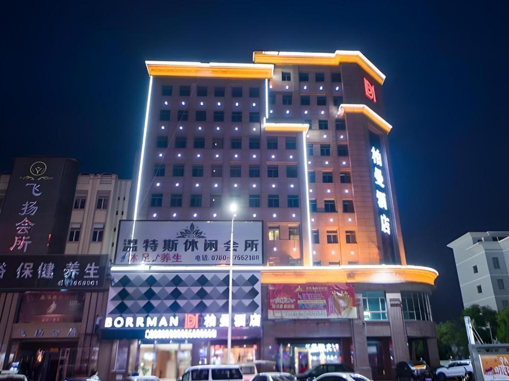 a tall building with lights on the side of it at Borrman Hotel Zhongshan Henglan Xiyong in Zhongshan