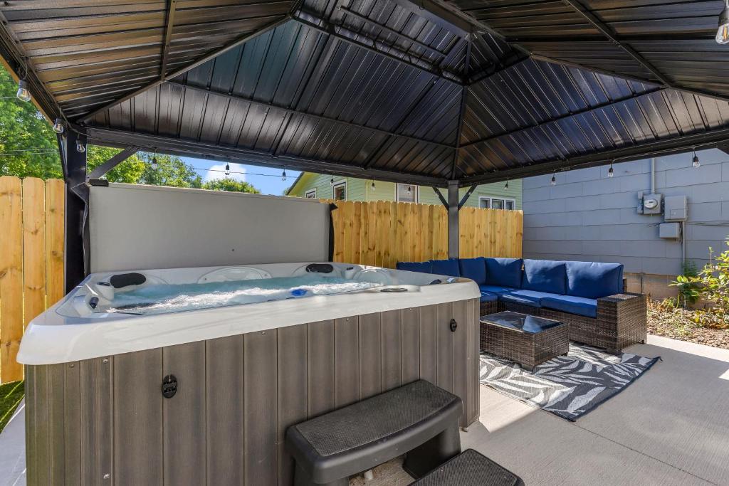 a jacuzzi tub in the middle of a patio at ArtGallery PrivateHotTub Sauna NearMountRushmore FamilyHome in Rapid City