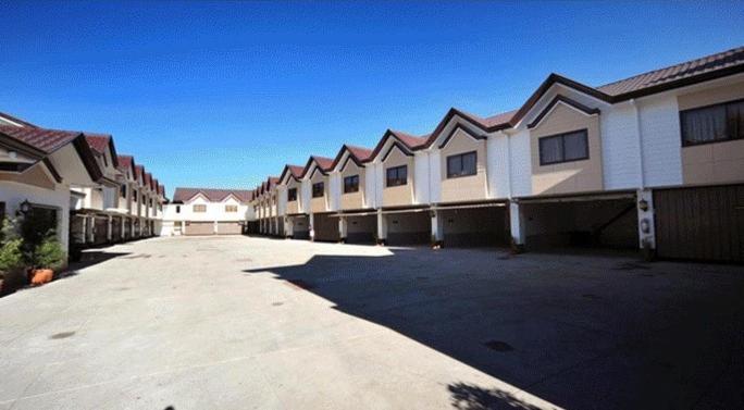 a row of houses in a parking lot at Hollywood Drive-In Hotel in Baguio