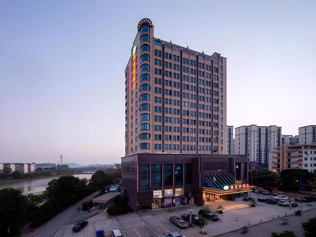 a large building in a city next to a river at Vienna Hotel Jiangxi Ji'an Yanjingfu in Ji'an