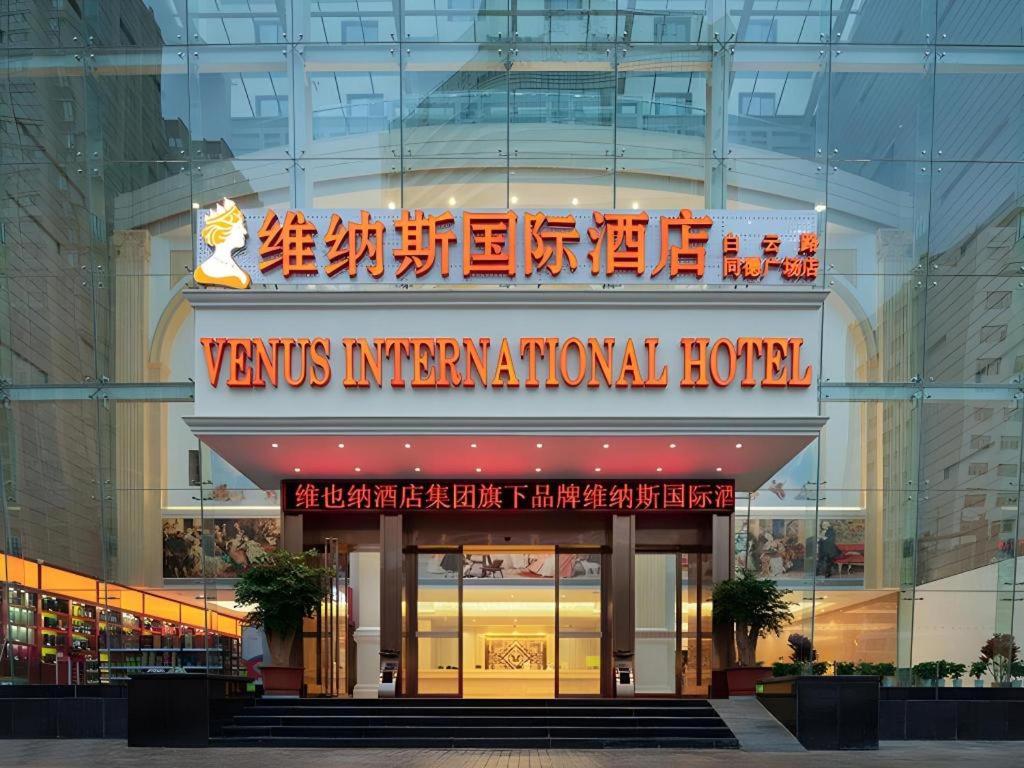 a building with a sign that reads venus international hotel at Venus International Hotel Kunming Baiyun Road Tongde Square in Kunming
