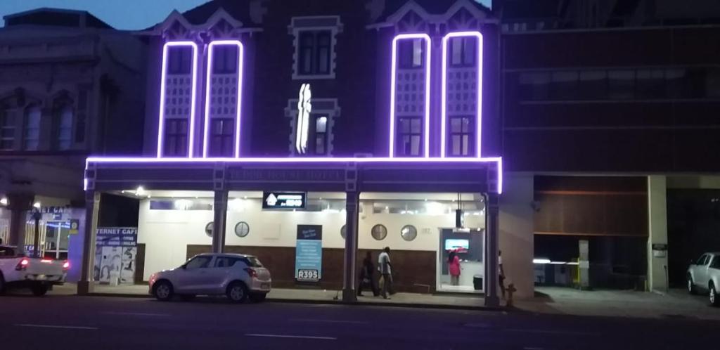 a building with purple lights on top of it at Tudor House Hotel in Durban