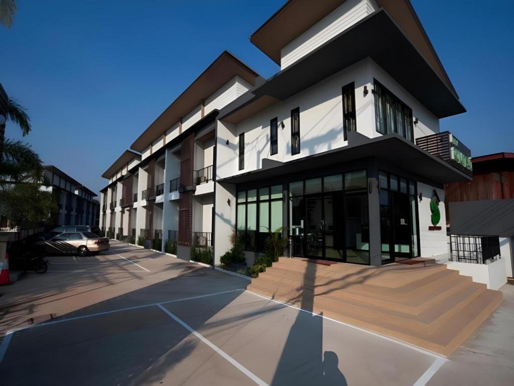a building with a car parked in front of it at Siamgrand Hotel in Nakhon Phanom