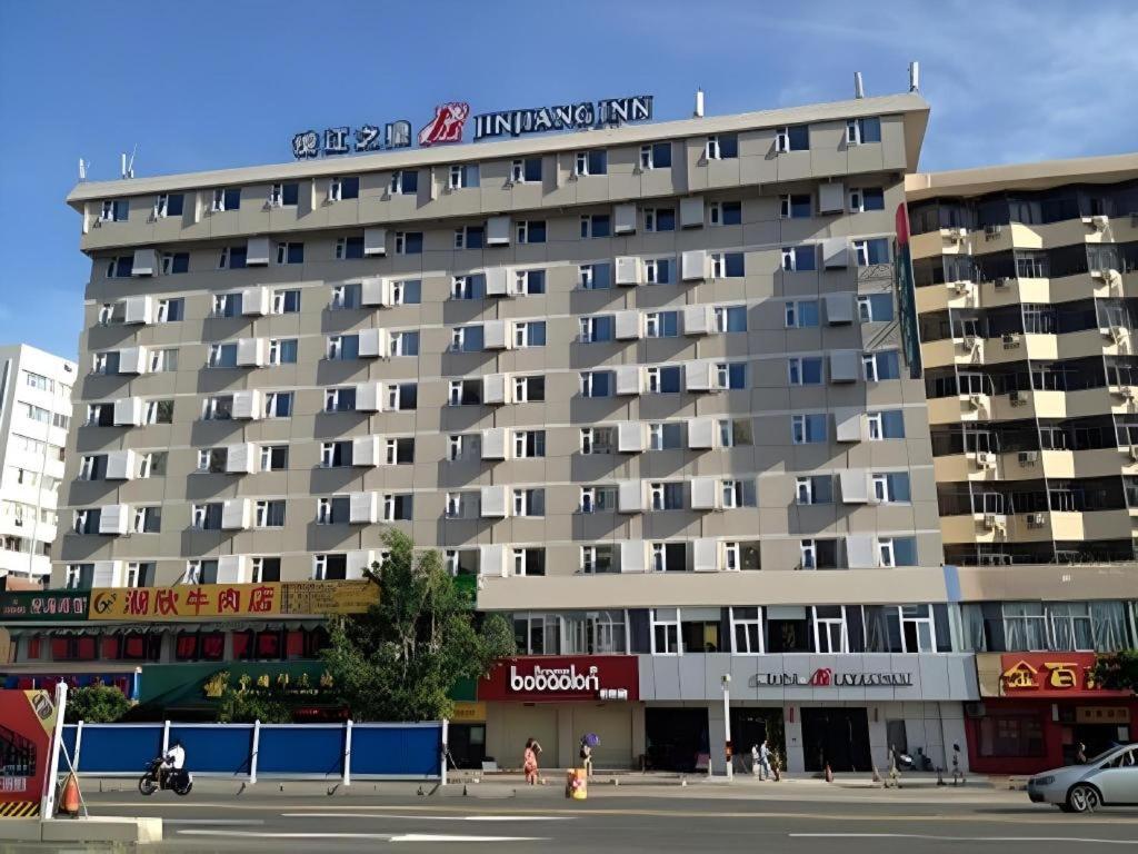 a large building with a sign on top of it at Jinjiang Inn Haikou Jinjiuling Park Branch in Haikou