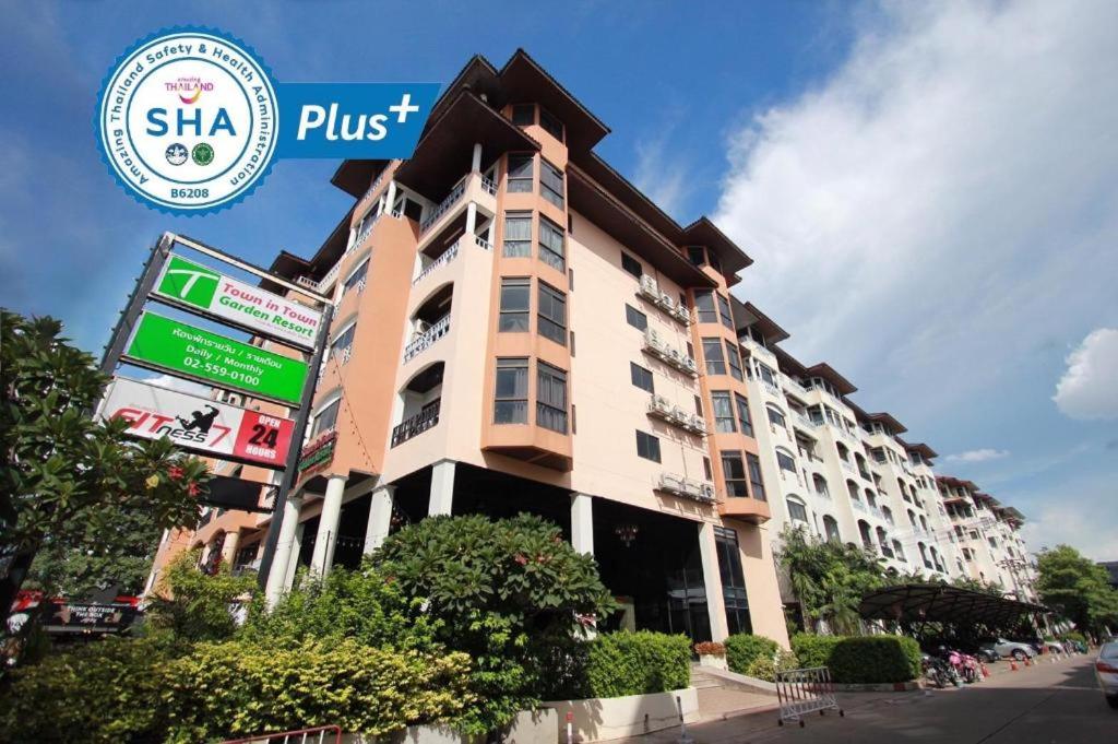 a large building with a sign in front of it at Town In Town Gardent Resort in Sathani Khlong Tan