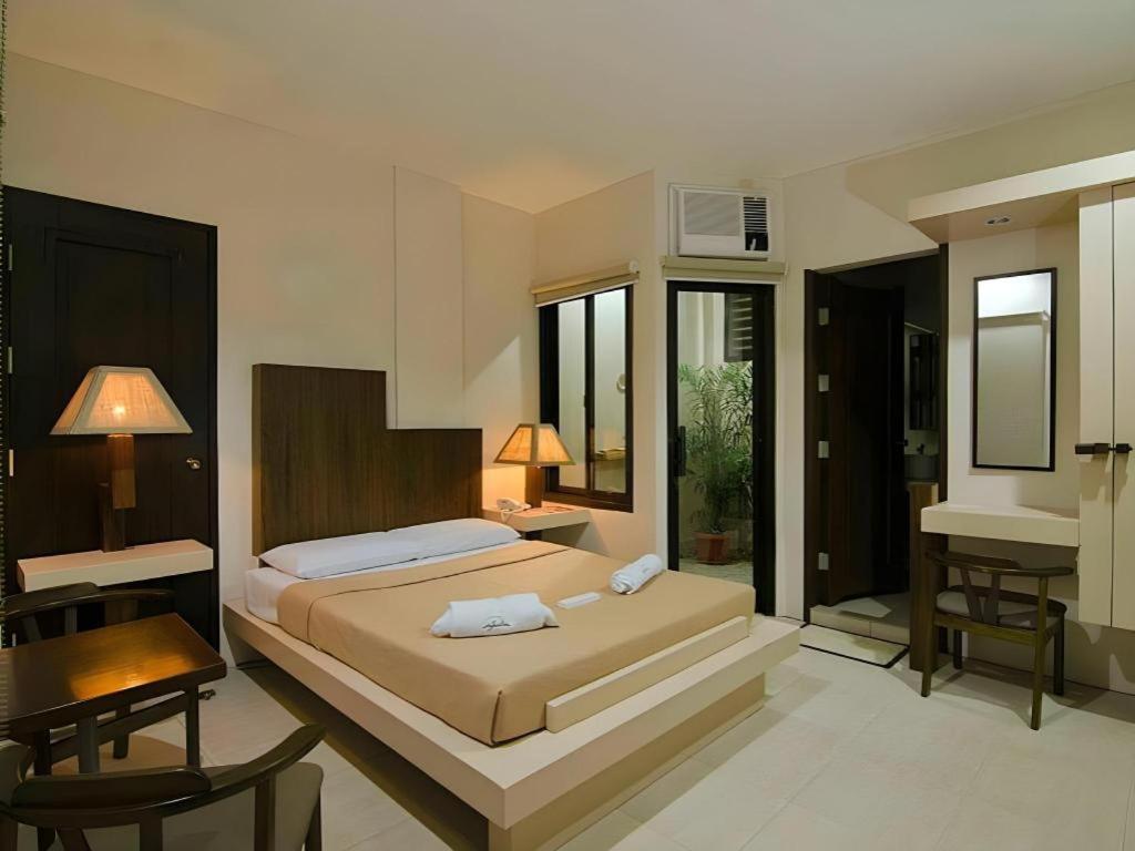 Giường trong phòng chung tại Hotel Joselina