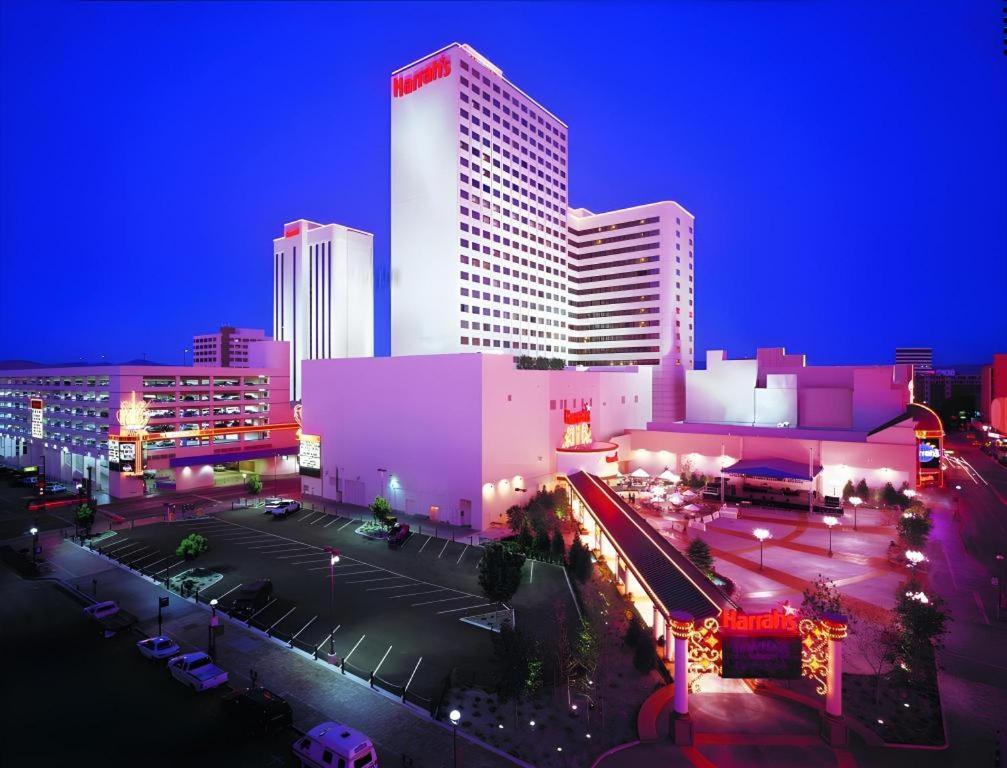 a city skyline with a tall building at night at Harrahs Hotel Reno in Reno