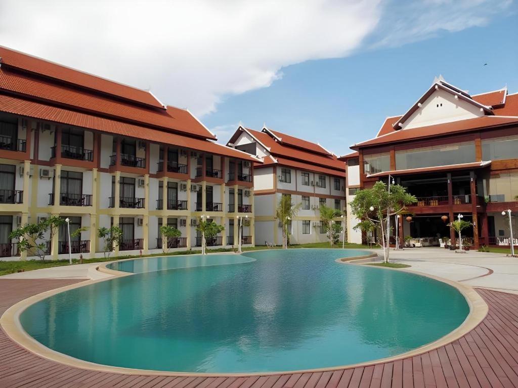 a large swimming pool in front of a building at Xishuangbanna Hotel Managed by Xandria Hotel in Ban Nongkham