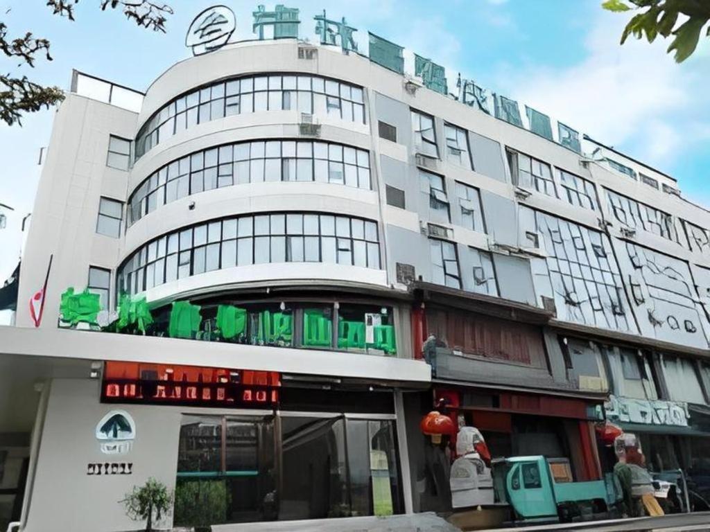 a large white building with a sign on it at GreeTree Inn Huainan Jinjialing Road Oriental General Hospital in Huainan