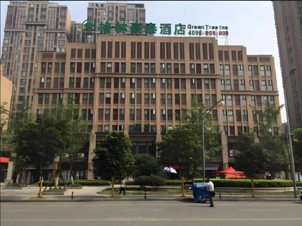 a large building with people walking in front of it at GreenTree Inn Chengdu North Railway Station Beichengtianjie Business Hotel in Chengdu