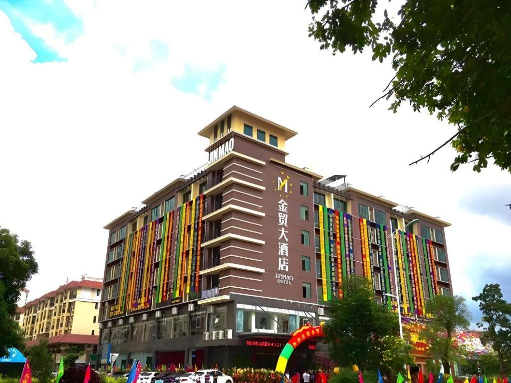 a building with a rainbow on the side of it at Qionghai Jin Mao Hotel in Qionghai