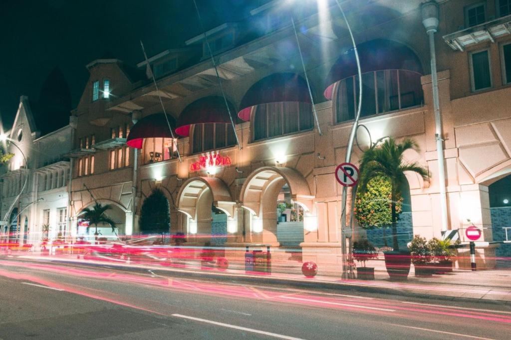 a building on the side of a street at night at Hotel Horison Arcadia Heritage Surabaya in Surabaya