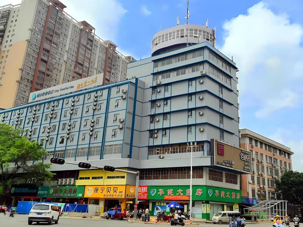 a tall building with a tower on top of it at City Comfort Inn Guigang Tangren Street in Guigang