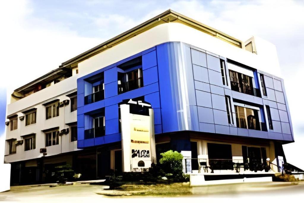 a blue and white building with a blue at Soledad Suites in Panglao