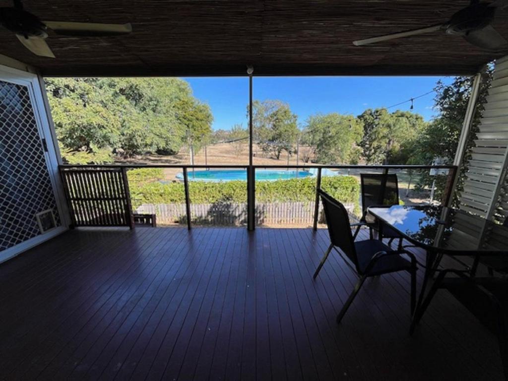 a screened in porch with a table and chairs on it at 111 Meson Street Gayndah in Gayndah