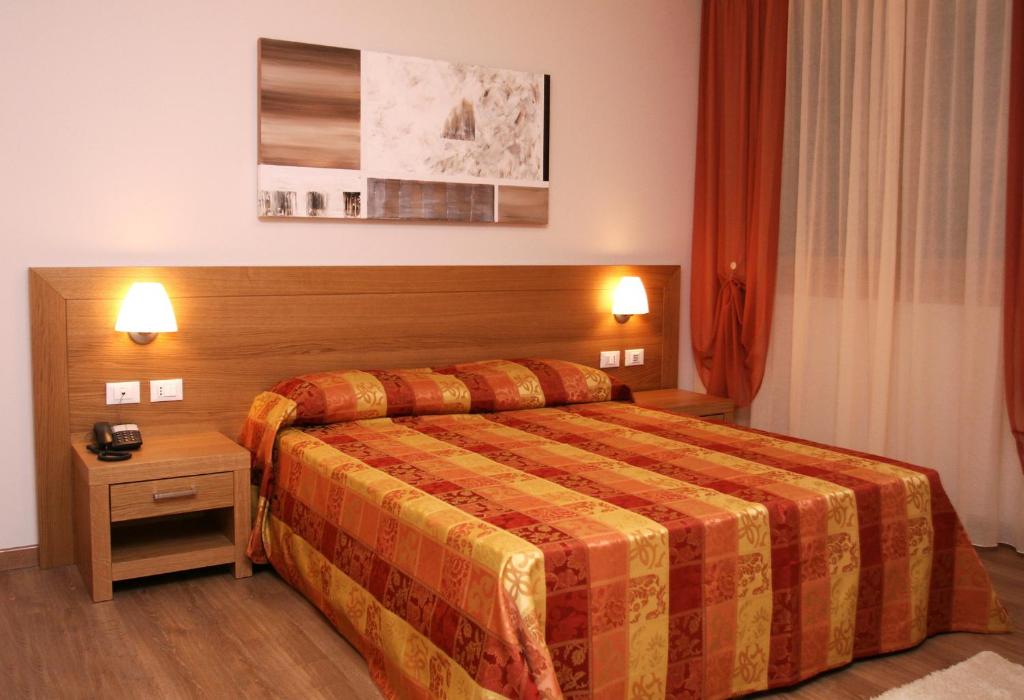 Postel nebo postele na pokoji v ubytování Hotel Calinferno