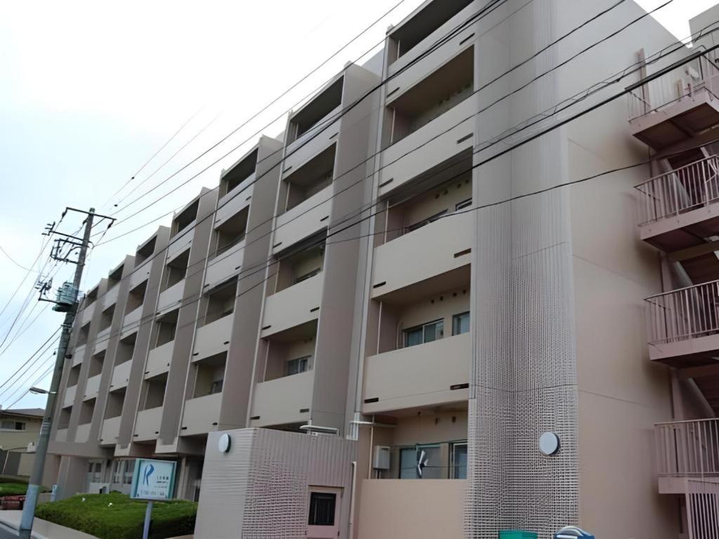 an apartment building with balconies on the side of it at Refre Forum in Tokyo