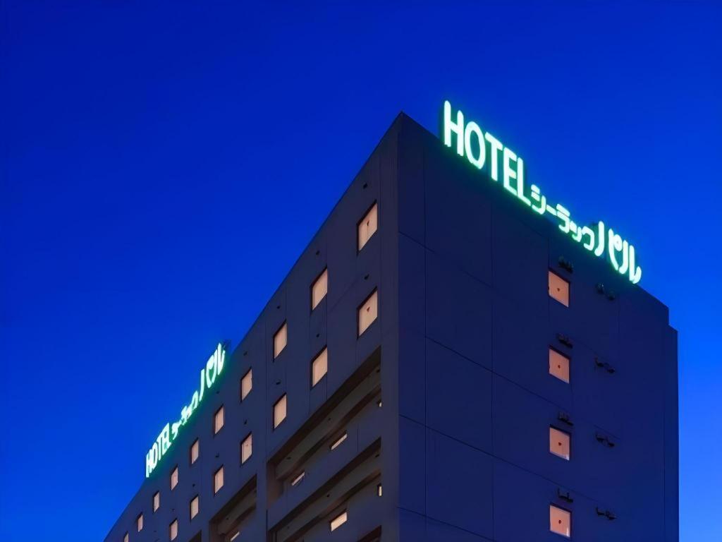 a building with neon signs on top of it at Hotel Sealuck Pal Takasaki in Takasaki