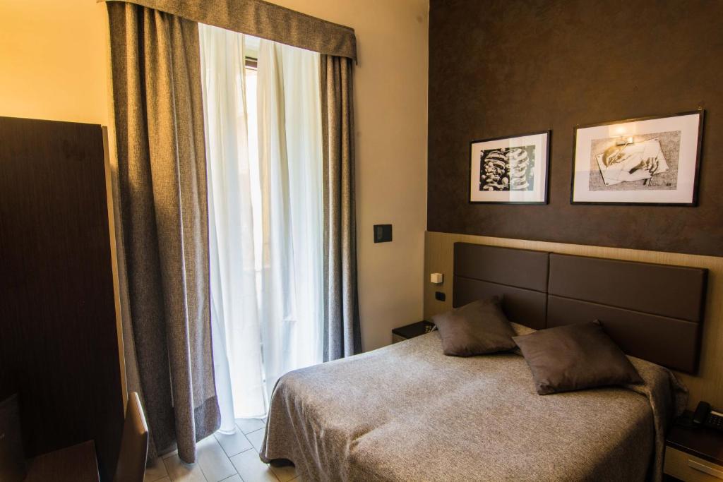 Postel nebo postele na pokoji v ubytování Hotel Charter