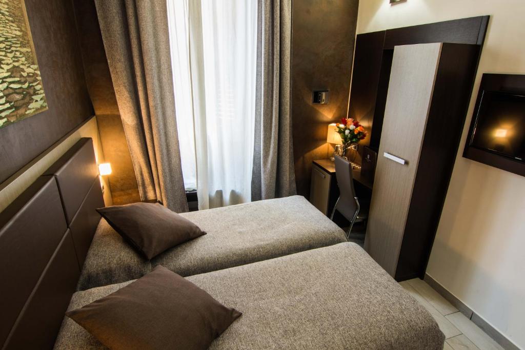 Postel nebo postele na pokoji v ubytování Hotel Charter
