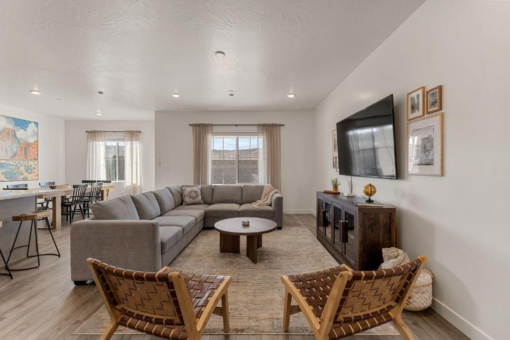 a living room with a couch and a tv at Adventure Basecamp townhouse in Washington