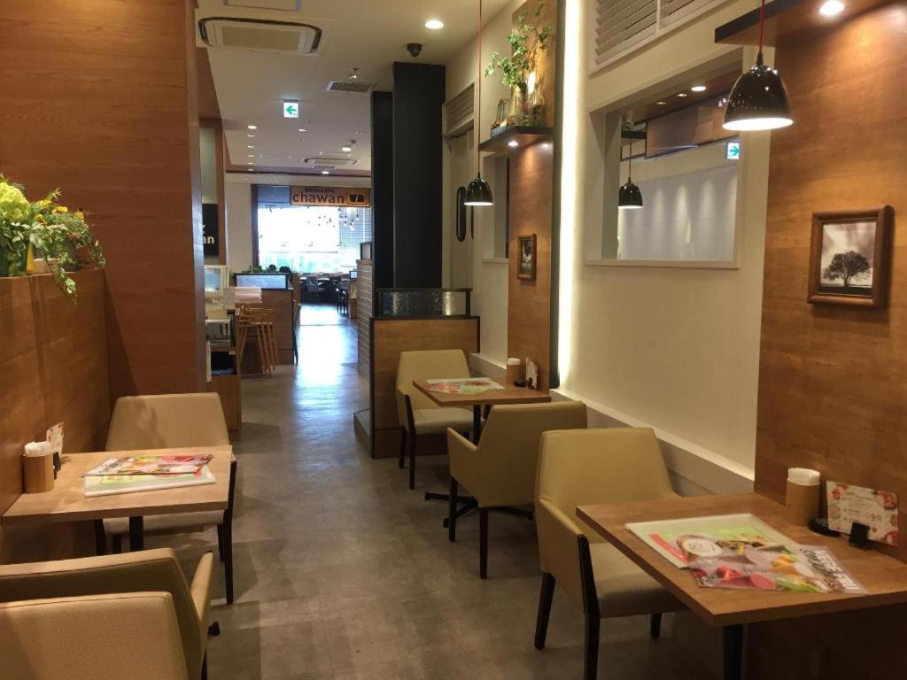 a dining room with tables and chairs in a restaurant at KEIKYU EX INN Keikyu Kawasaki-Station in Kawasaki