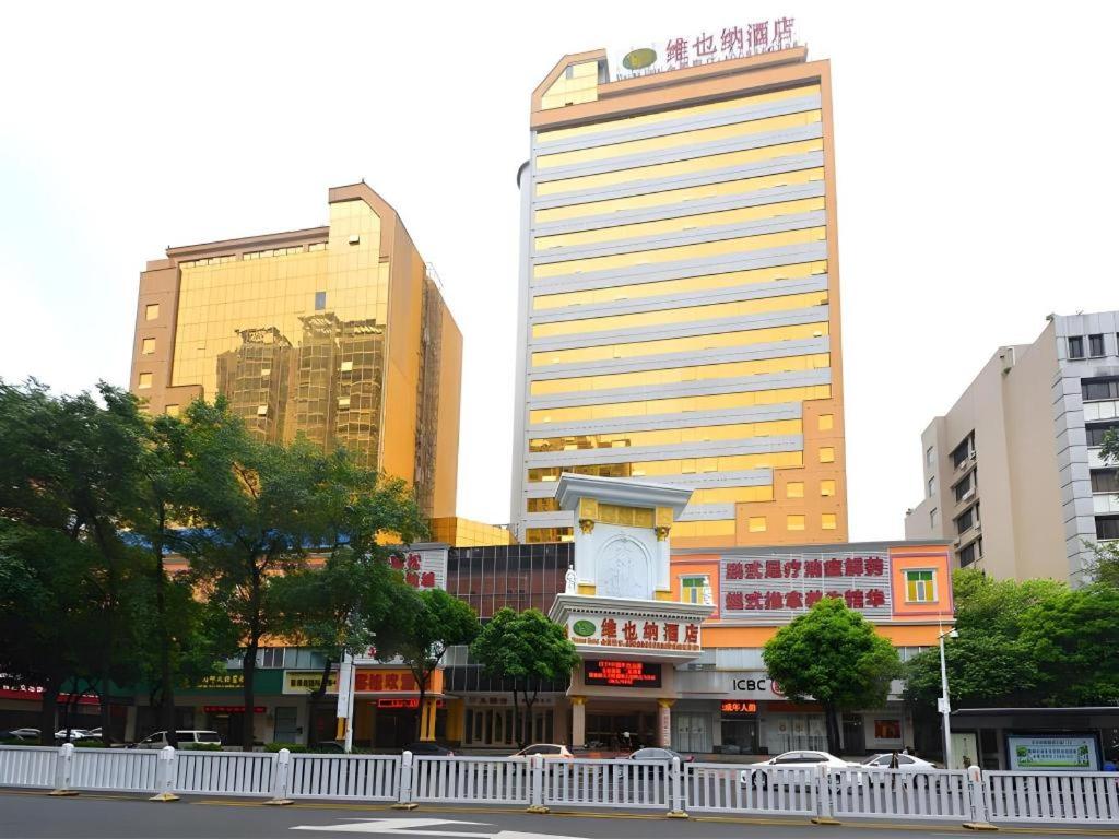 a city with tall buildings and a street at Vienna Hotel 5.0 Qingyuan City Plaza Lianjiang Road in Qingyuan