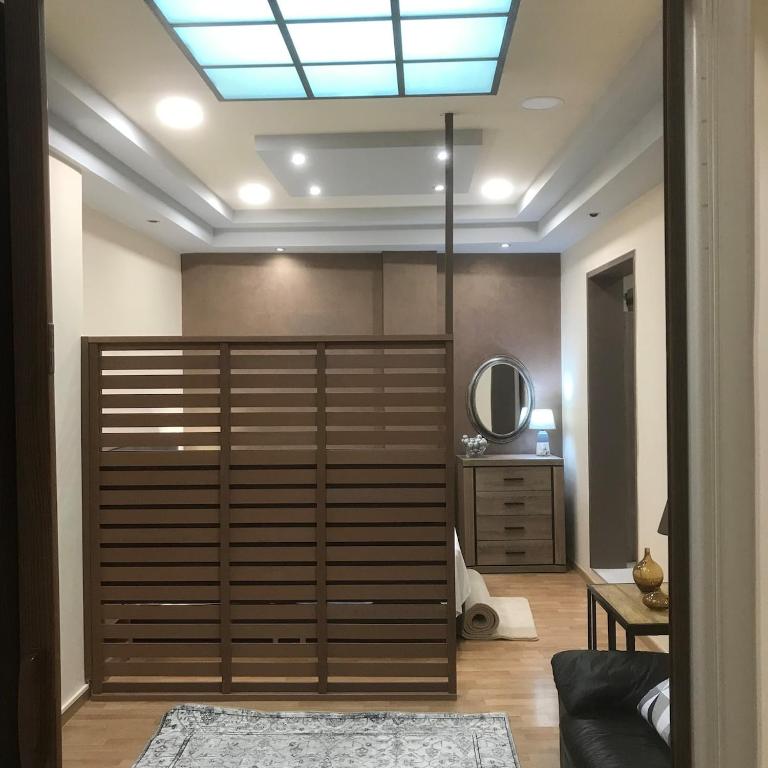 a room with a large wooden closet with a mirror at Διαμέρισμα στο κέντρο της πόλης in Thiva
